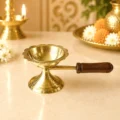 Premium brass loban guggal dhoop burner with wooden handle for burning sambrani, camphor and incense during daily puja, havan and temple rituals.