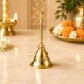 Premium pure brass pooja bell with traditional long handle for home temple, aarti, daily worship and religious ceremonies.